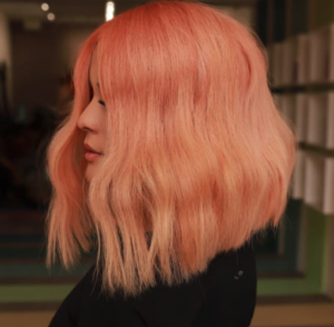 Woman with pink hair and long bob