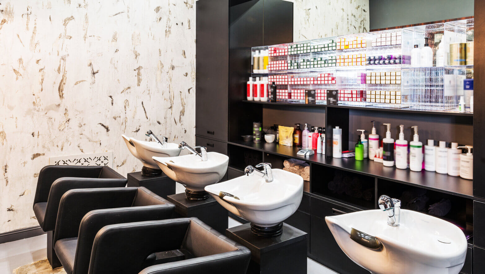 Image of a salon with hair care products and wash basin for hair
