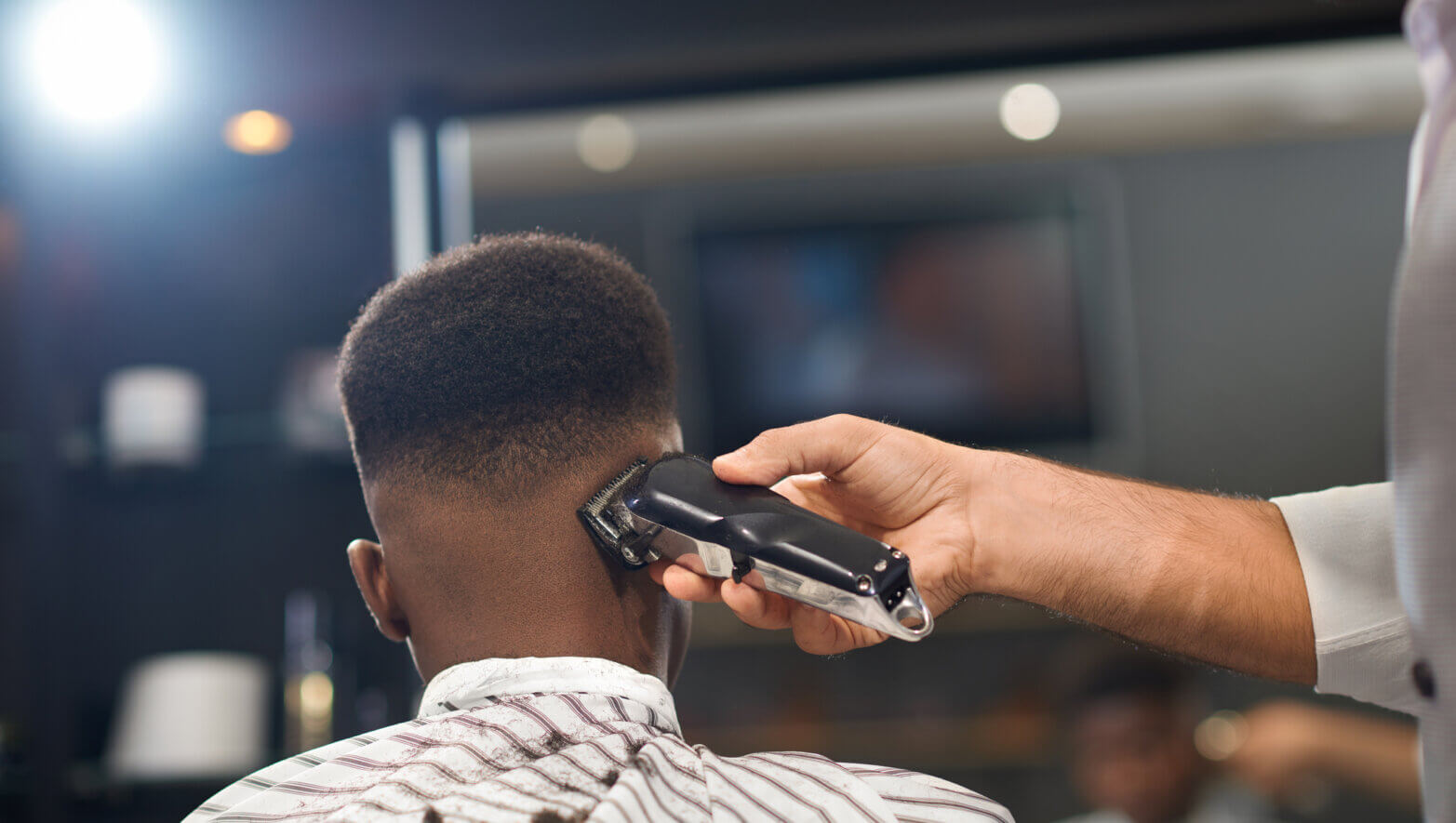 Image of a barber shaving his client's hair