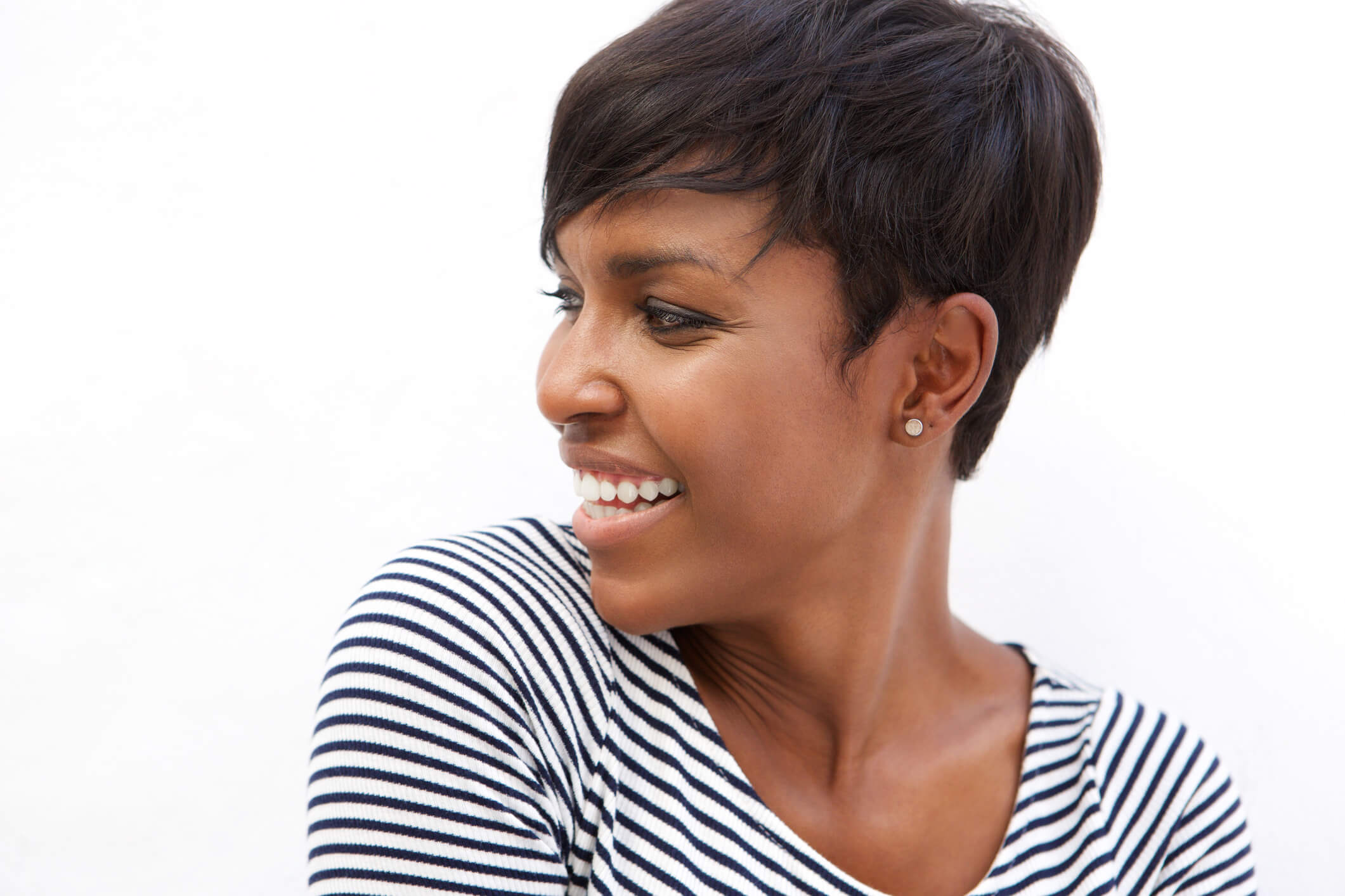 Image of a young African American woman smiling and looking away