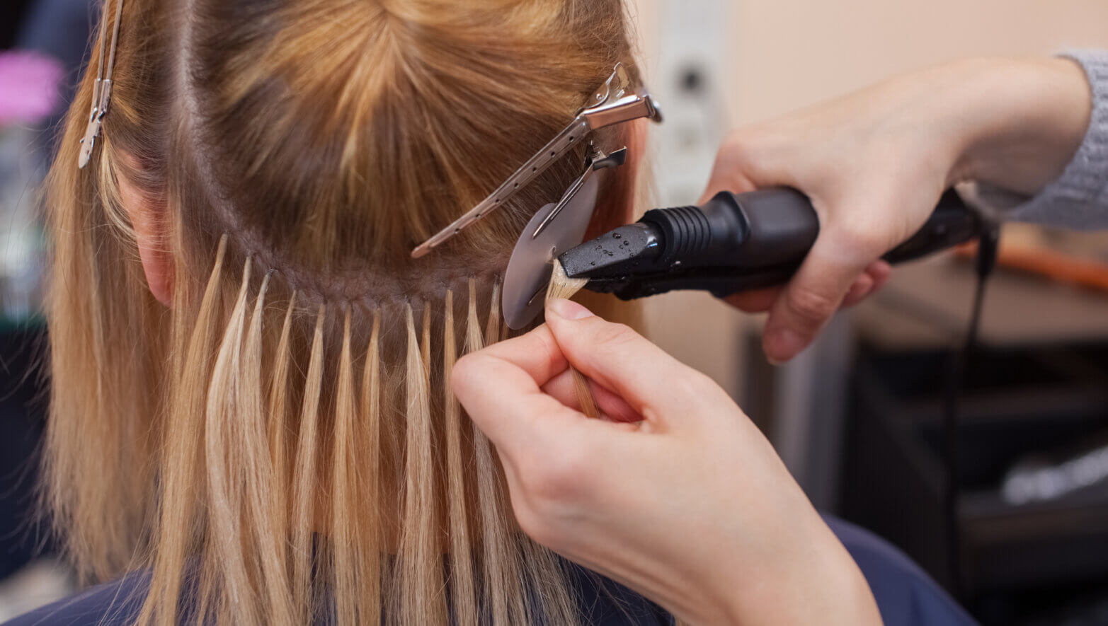 Image of a female stylist styling her client's hair
