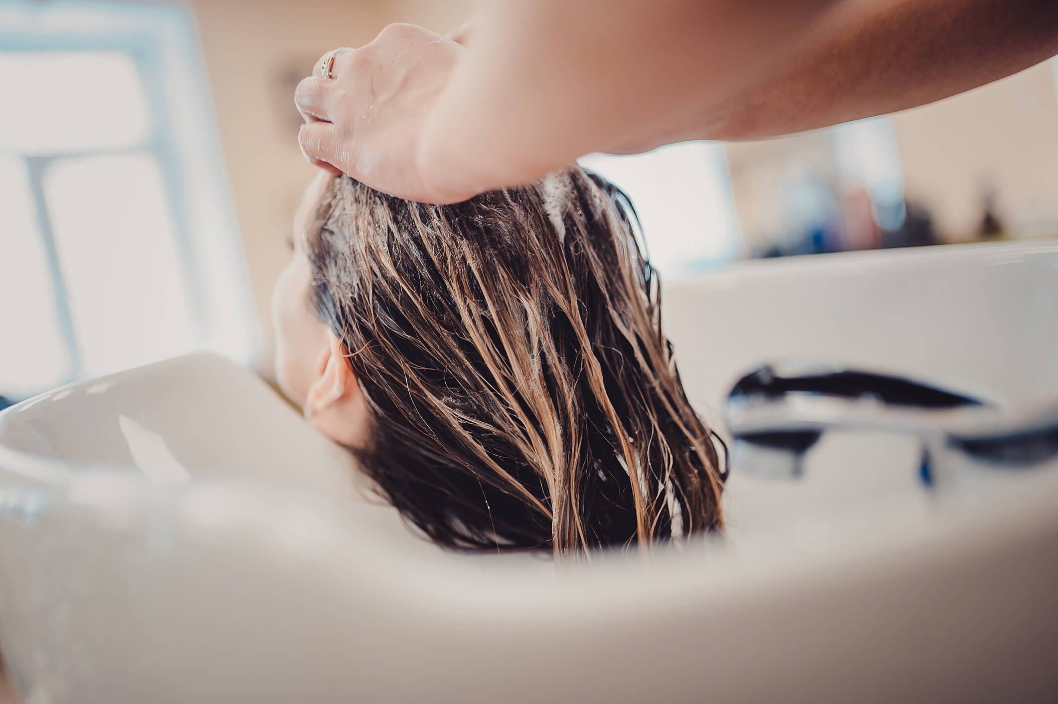 Image of a woman washing colored hair
