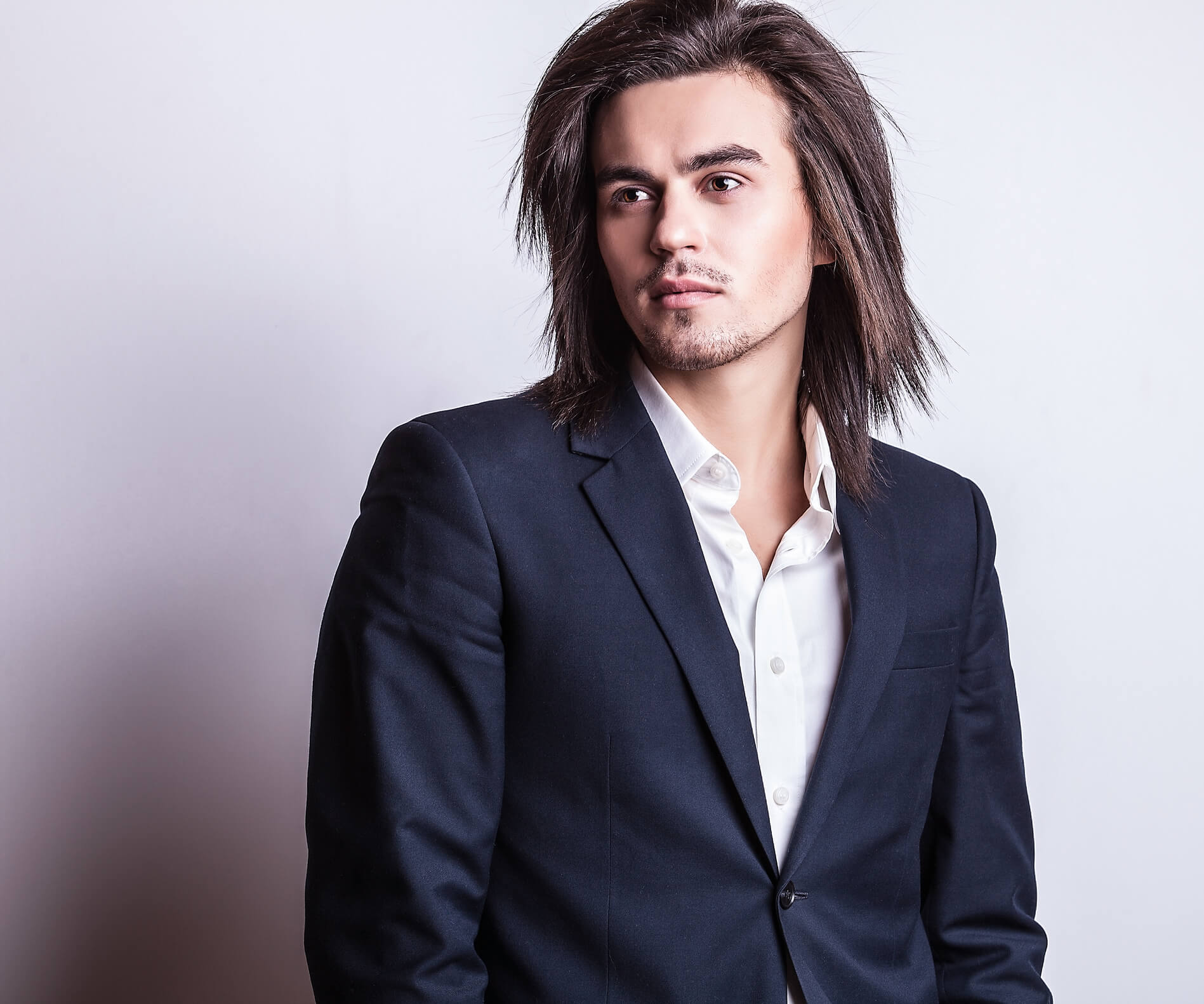 Image of an elegant young handsome man with long hair