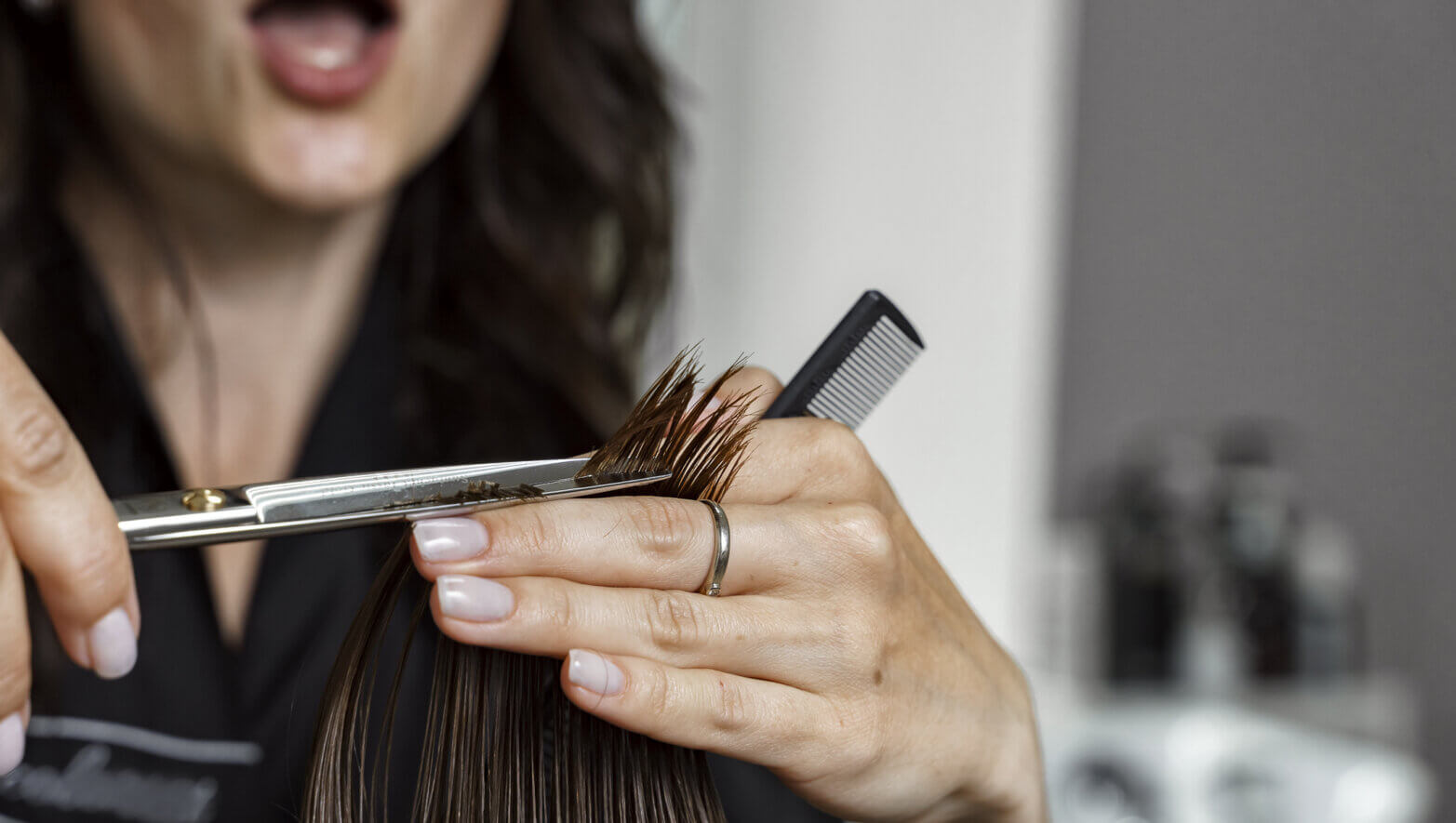 hairdresser shocked with open mouth cutting hair
