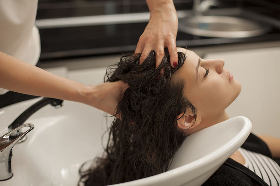 hair salon client enjoying scalp massaging