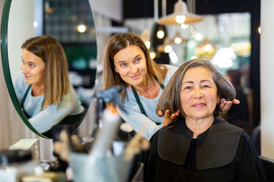 hairdresser offering hairstyling to client