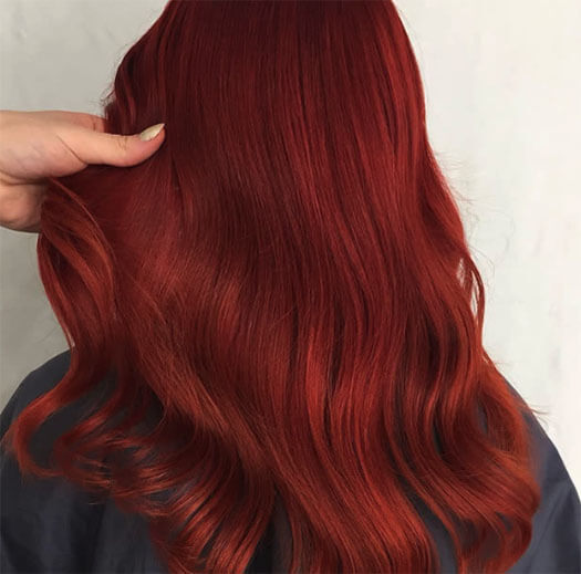 hairstylist holding client red hair