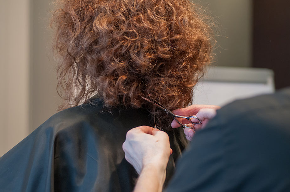 stylist trimming client hair