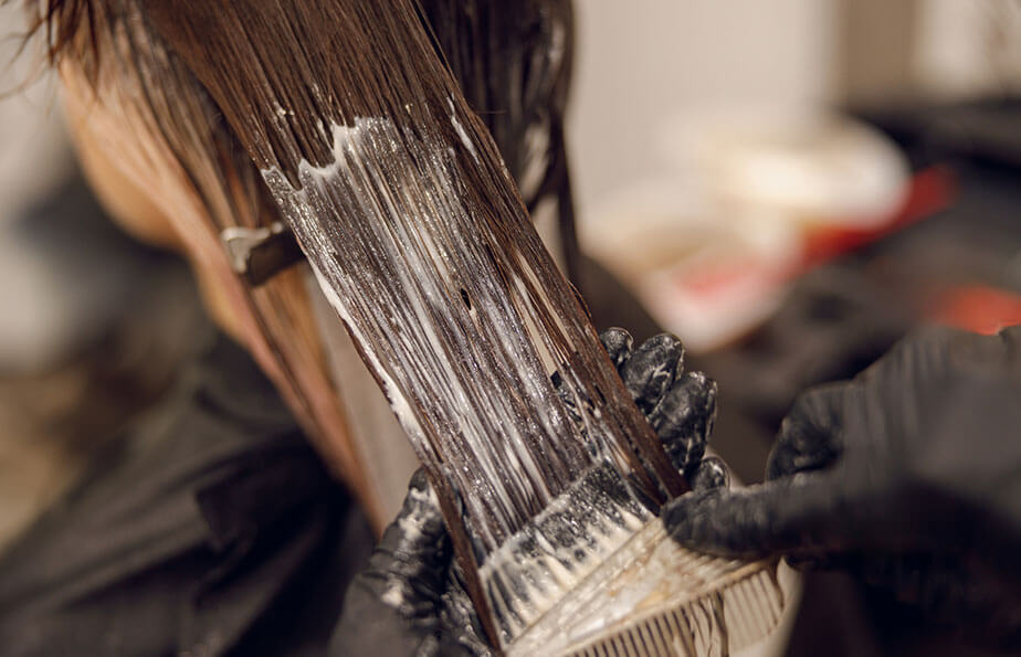 closeup hairdresser dyeing hair