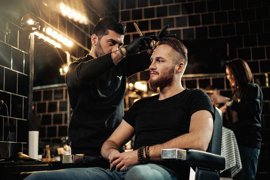 barber combing client hair