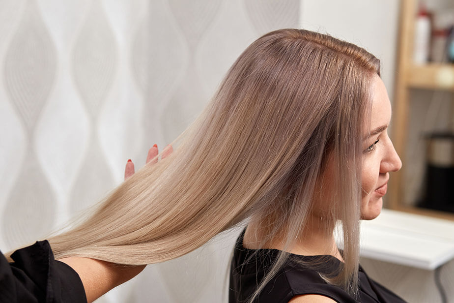 stylist holds client hair in salon