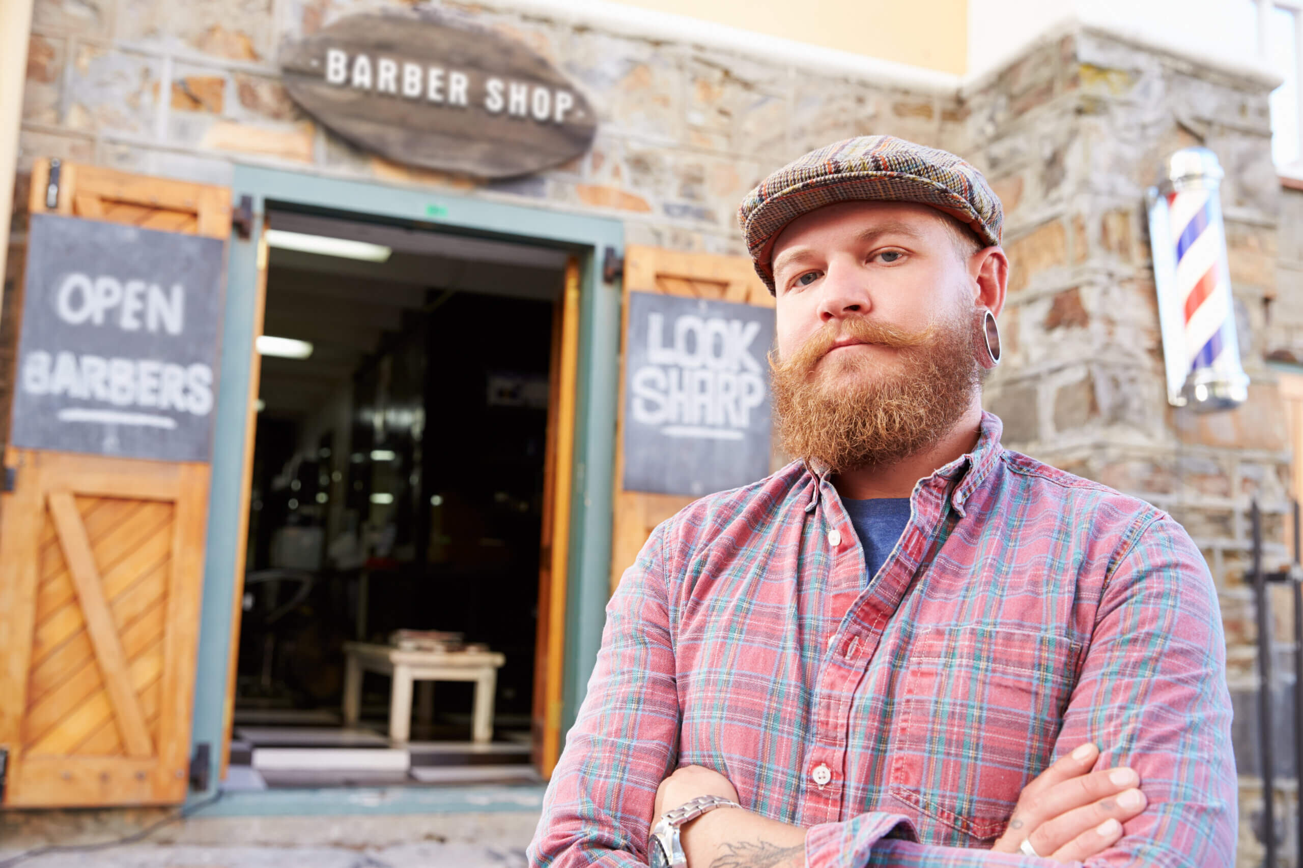 Portrait Of Hipster Barber Standing Outside Shop