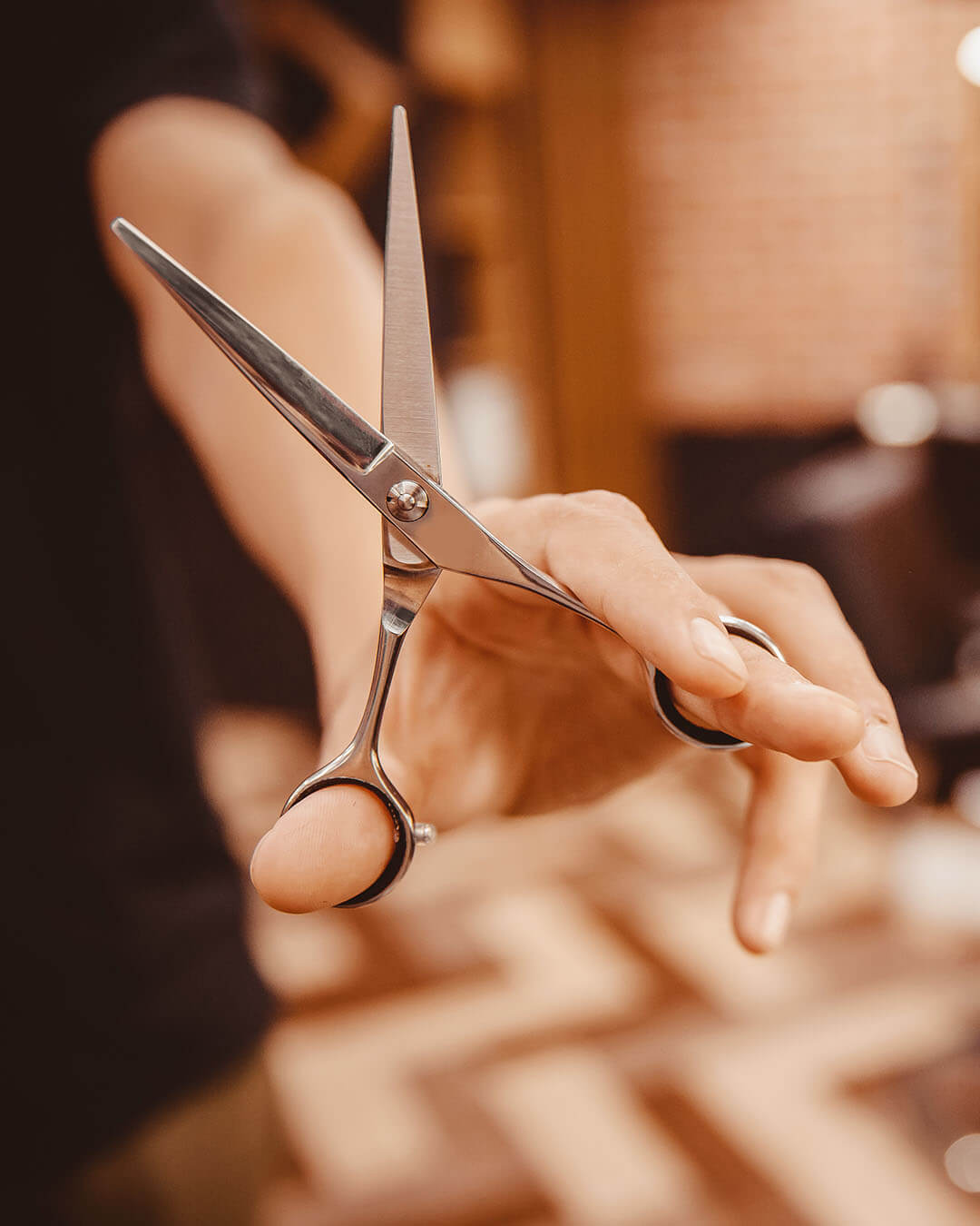 holding scissors up in salon