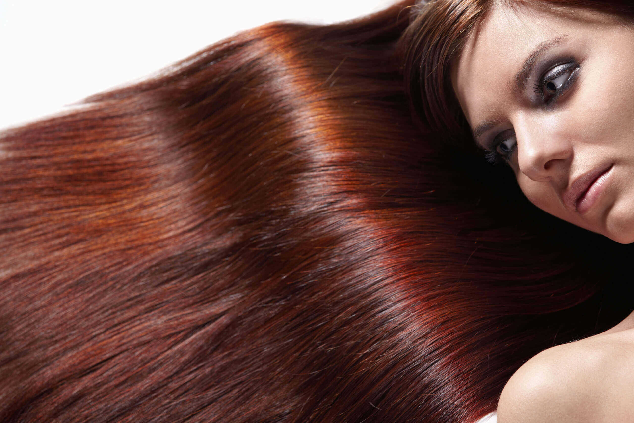 Caring for the health of hair. Girl with beautiful hair on a white background