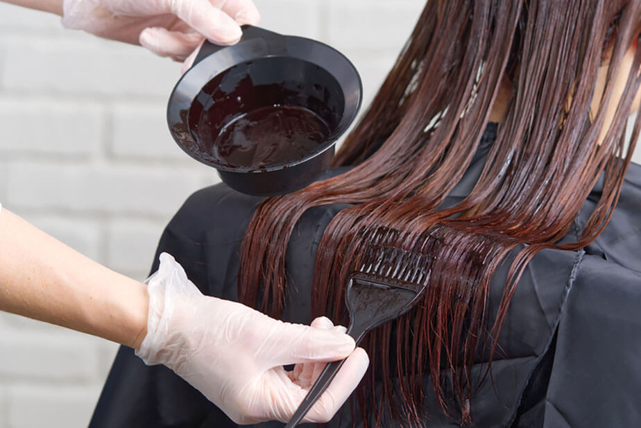 applying dark dye to hair