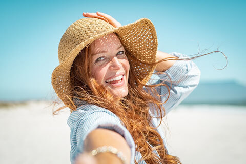 portrait smiling woman on beach