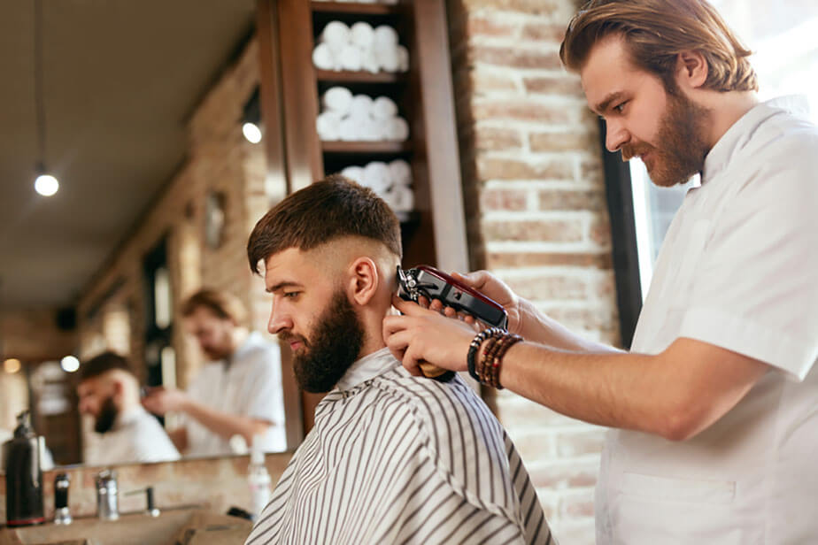 barber trims client hair